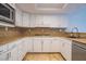 A kitchen featuring white cabinets, granite countertops, and stainless steel appliances at 7365 Mission Hills Dr, Las Vegas, NV 89113