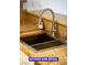 Modern kitchen sink with cutting board and sleek faucet and granite countertops at 7365 Mission Hills Dr, Las Vegas, NV 89113