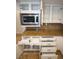 White kitchen cabinets with drawers, cabinets, and stainless steel microwave at 7365 Mission Hills Dr, Las Vegas, NV 89113