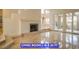 Spacious living room with a fireplace, chandelier in the dining area, and access to the outdoor patio at 7365 Mission Hills Dr, Las Vegas, NV 89113