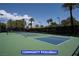 Community pickleball court with blue and green surface, surrounded by trees and clear sky at 7365 Mission Hills Dr, Las Vegas, NV 89113