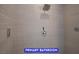 Walk-in shower featuring stylish tiled walls with a modern shower head and sleek hardware at 7365 Mission Hills Dr, Las Vegas, NV 89113