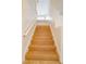 Beautifully finished hardwood stairs featuring painted risers and railing, landing and tiled floors at 7365 Mission Hills Dr, Las Vegas, NV 89113