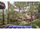Scenic view from primary bedroom showcasing lush greenery, trees, and a glimpse of nearby houses at 7365 Mission Hills Dr, Las Vegas, NV 89113