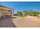 Spacious gravel backyard with a patch of artificial turf and covered patio, ideal for outdoor relaxation at 7856 Tolberts Mill Dr, Las Vegas, NV 89131