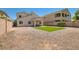 Wide view of the home's backyard with gravel landscaping and a patch of artificial turf at 7856 Tolberts Mill Dr, Las Vegas, NV 89131