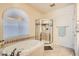A bright bathroom featuring a soaking tub and glass enclosed shower to create a spa-like experience at 7856 Tolberts Mill Dr, Las Vegas, NV 89131