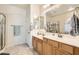 Bathroom featuring double sinks, white countertops and a glass enclosed shower creates a spa-like experience at 7856 Tolberts Mill Dr, Las Vegas, NV 89131