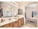 Bathroom featuring double sinks, white countertops and mirror gives access to main bedroom at 7856 Tolberts Mill Dr, Las Vegas, NV 89131