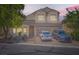 Two-story home features a well-kept front yard and an attached two-car garage, with a sunset background at 7856 Tolberts Mill Dr, Las Vegas, NV 89131