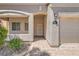 Inviting home exterior with stone accents, a covered entryway, a paved walkway, and attached garage at 7856 Tolberts Mill Dr, Las Vegas, NV 89131