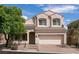 Charming two-story home showcasing a tile roof, attached garage, and low-maintenance front yard landscaping at 7856 Tolberts Mill Dr, Las Vegas, NV 89131