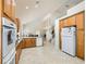 Open kitchen showcasing light wood cabinets, tile floors, an island, and a breakfast nook at 7856 Tolberts Mill Dr, Las Vegas, NV 89131