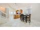 Open-concept kitchen and dining area featuring light wood cabinets, tile floors, and ample natural light at 7856 Tolberts Mill Dr, Las Vegas, NV 89131