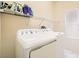 Functional laundry room with a washer, dryer, and shelving for storage and a window for natural light at 7856 Tolberts Mill Dr, Las Vegas, NV 89131