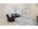 Bright living room features high ceilings, a sliding glass door, neutral walls, and plush seating at 7856 Tolberts Mill Dr, Las Vegas, NV 89131