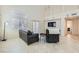 Inviting living room with tile flooring, ample natural light, and comfortable furnishings at 7856 Tolberts Mill Dr, Las Vegas, NV 89131