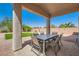 Covered patio featuring an outdoor dining set, perfect for entertaining in a serene backyard setting at 7856 Tolberts Mill Dr, Las Vegas, NV 89131