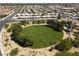Aerial view showcases a community park featuring a circular grassy area, mature trees and walking path at 7904 Seabourn Ct, Las Vegas, NV 89129