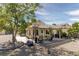 Charming backyard featuring a pergola with seating, hanging chair, mature trees, and desert landscaping at 7904 Seabourn Ct, Las Vegas, NV 89129