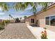 Backyard featuring desert landscaping, a concrete patio, and secure gated access at 7904 Seabourn Ct, Las Vegas, NV 89129