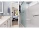 Bright bathroom features a tiled shower with glass doors and a glimpse into the adjacent bedroom at 7904 Seabourn Ct, Las Vegas, NV 89129