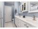 Well-lit bathroom featuring double sinks, a vanity with storage, and a glass-enclosed shower at 7904 Seabourn Ct, Las Vegas, NV 89129