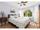 Cozy bedroom with a large window view, ceiling fan, and comfortable decor elements at 7904 Seabourn Ct, Las Vegas, NV 89129