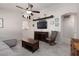 Comfortable living room with neutral tones, ceiling fan, and tile flooring provides an inviting space at 7904 Seabourn Ct, Las Vegas, NV 89129