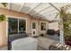 Cozy covered patio featuring stylish pavers, comfortable seating, and a charming pergola with climbing plants at 7904 Seabourn Ct, Las Vegas, NV 89129