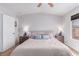 Bright bedroom with a ceiling fan, two nightstands, and large window offering natural light at 7912 Horn Beam Ct, Las Vegas, NV 89131