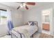 Cozy bedroom with a ceiling fan and en suite bathroom, perfect for relaxing after a long day at 7912 Horn Beam Ct, Las Vegas, NV 89131