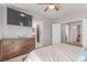 Bright bedroom with a dresser and a television mounted on the wall for easy viewing at 7912 Horn Beam Ct, Las Vegas, NV 89131