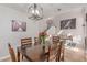 Dining area with wood table and chairs, open to the living area, showcasing the home's layout at 7912 Horn Beam Ct, Las Vegas, NV 89131