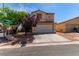 Charming home featuring a two-car garage, complemented by drought-resistant landscaping and mature trees at 7912 Horn Beam Ct, Las Vegas, NV 89131