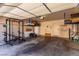 Open garage space featuring workout area, storage, and access to the home's interior at 7912 Horn Beam Ct, Las Vegas, NV 89131