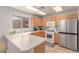 Well-lit kitchen featuring wood cabinets, stainless steel appliances, and ample counter space at 7912 Horn Beam Ct, Las Vegas, NV 89131