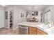 Open concept kitchen with stainless steel dishwasher and view into the dining and living areas at 7912 Horn Beam Ct, Las Vegas, NV 89131