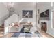 Bright, open living room with staircase, tile floors, a comfortable couch, and a large TV at 7912 Horn Beam Ct, Las Vegas, NV 89131