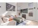 Bright living room with staircase, tile floors, neutral decor, high ceilings and ample natural light at 7912 Horn Beam Ct, Las Vegas, NV 89131
