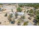 Expansive rural property with a single-story home, detached garage, trees, and a large open lot in a desert environment at 7960 Quarter Horse Ave, Pahrump, NV 89061