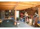 Unfinished basement features exposed ceiling, shelves, and various tools and appliances at 7960 Quarter Horse Ave, Pahrump, NV 89061