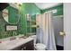 Stylish bathroom featuring green tiled wall, modern vanity, and walk-in shower at 7960 Quarter Horse Ave, Pahrump, NV 89061