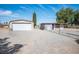 Exterior view featuring garage, chain-link fence, and desert landscape at 7960 Quarter Horse Ave, Pahrump, NV 89061