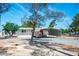 Charming single-story home featuring a metal carport, white siding, and a well-maintained gravel yard at 7960 Quarter Horse Ave, Pahrump, NV 89061