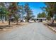 Exterior view of a house with desert landscaping and a long driveway at 7960 Quarter Horse Ave, Pahrump, NV 89061