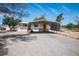 Charming home exterior with a covered carport and low-maintenance gravel yard at 7960 Quarter Horse Ave, Pahrump, NV 89061