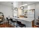 Bright kitchen featuring a breakfast bar, pendant lighting, white cabinets, and an efficient layout at 7960 Quarter Horse Ave, Pahrump, NV 89061
