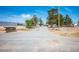 Gated property entrance with dirt driveway and chainlink fencing at 7960 Quarter Horse Ave, Pahrump, NV 89061
