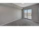 Bright bedroom featuring a sliding glass door to a balcony with city views and neutral decor at 8255 S Las Vegas Blvd # 2004, Las Vegas, NV 89123
